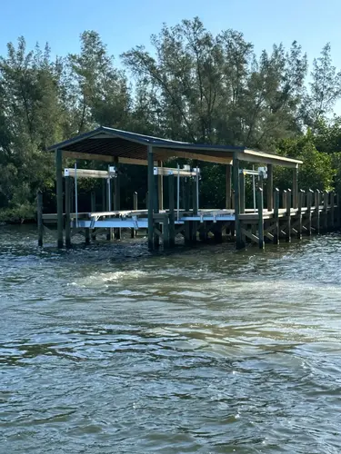 Durable marine construction with boat lifts installed on a residential dock